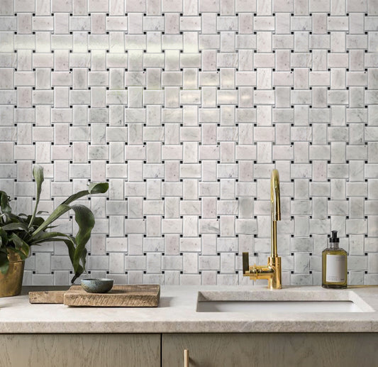 Polished white Bianco Carrara basketweave marble mosaic tiles with black dots on kitchen backsplash