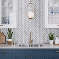 Polished Eastern White and Blue marble herringbone mosaic tile backsplash in kitchen setting