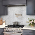 White polished Bianco Carrara marble herringbone mosaic tile backsplash in kitchen wall