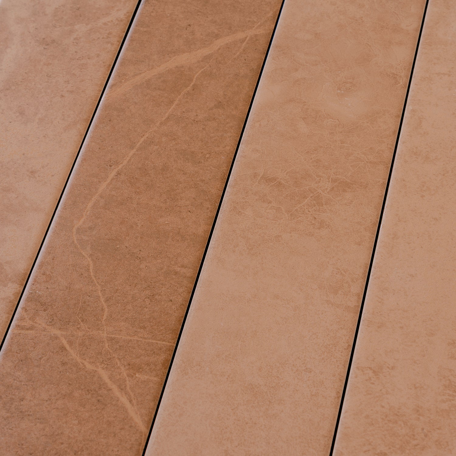 Sunbaked terracotta 3x24 matte porcelain plank tile with natural stone texture in warm earthy tones