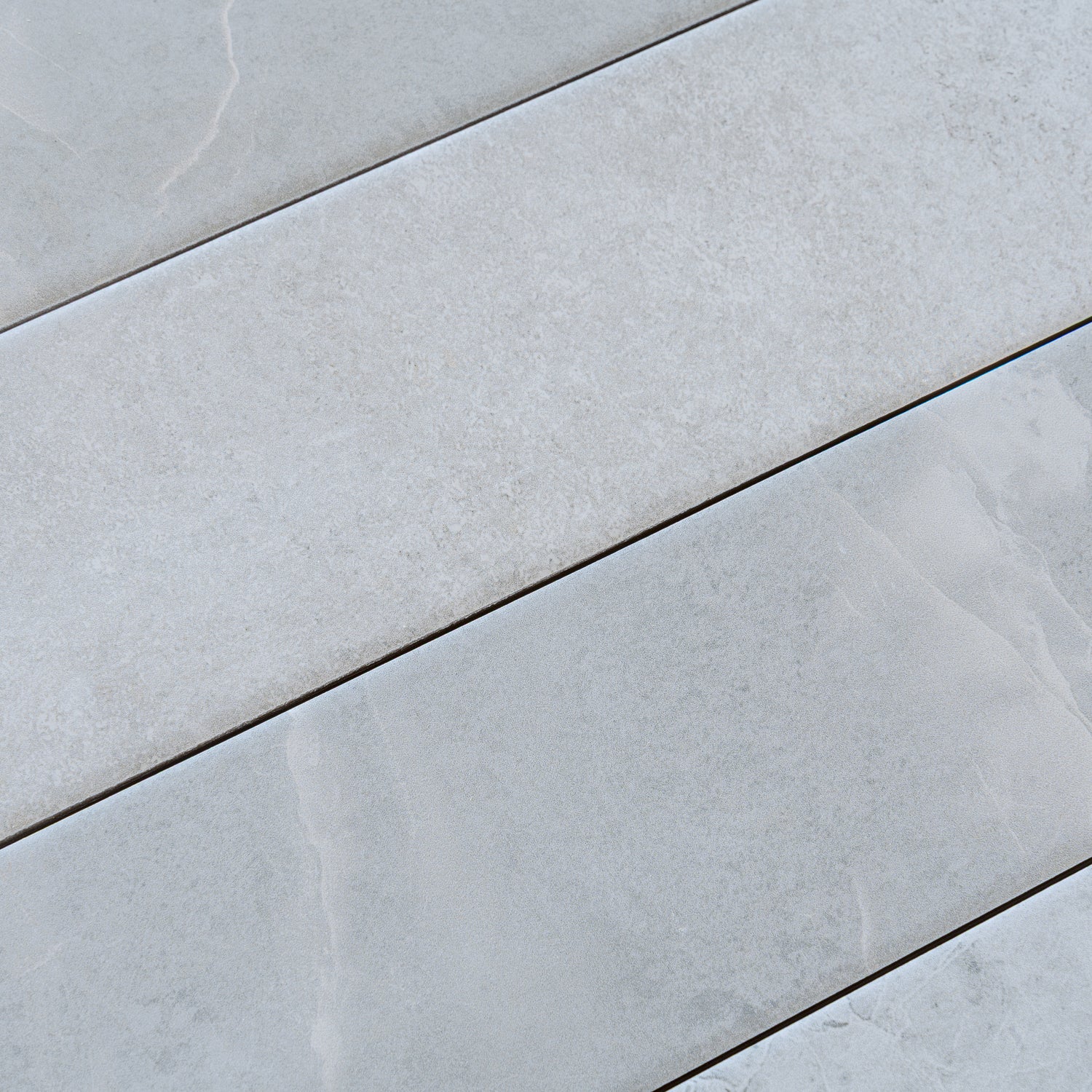 Soft grey matte porcelain plank tile 3x24 inch with subtle textured surface and natural stone look