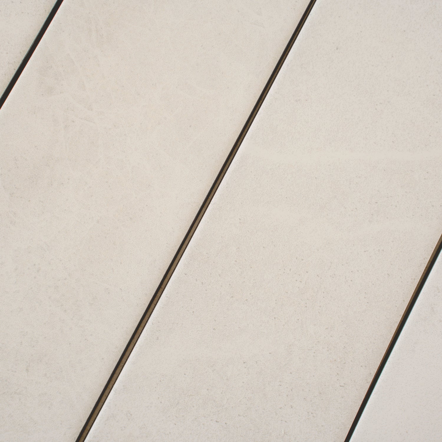 Soft white matte porcelain plank tile in 3x24 inch size with subtle texture and grout lines