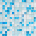 Glossy white and various blue square glass mosaic tiles arranged in a grid pattern