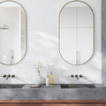 Polished white Thassos marble arabesque mosaic tile wall in bathroom setting