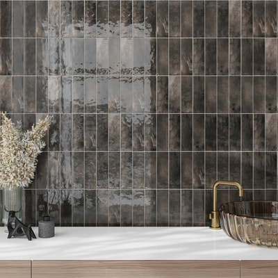 Glossy black ceramic subway tile 2.5x8 inches installed on wall