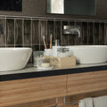 Black glossy ceramic pencil tile trims 1x8 inch on bathroom wall