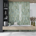 Sage green 2.5x8 glossy ceramic subway tile wall with beveled edges in interior space