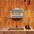 Glossy red ceramic subway tile 2.5x8 inches installed on bathroom wall