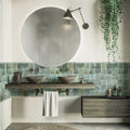 Blue glossy ceramic square tiles 4x4 installed as bathroom wall backsplash