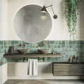 Green square ceramic wall tile with matte finish, used as bathroom backsplash