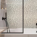 White glossy glass and marble penny round mosaic tile on bathroom wall and shower enclosure