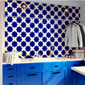 Cobalt blue glossy ceramic star-shaped 5x5 tiles installed on kitchen backsplash
