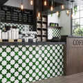 Dark green glossy ceramic cross-shaped tile 5x5 inches on commercial backsplash and wall