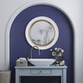 Indigo blue glossy porcelain penny round tile backsplash in a bathroom wall setting