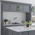 Glossy gray porcelain penny round mosaic tile backsplash in kitchen wall setting