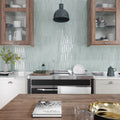 Pistachio green glossy ceramic picket tile backsplash with vertical elongated hexagon tiles in kitchen wall