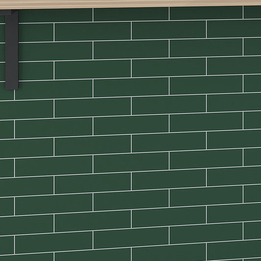 matte green ceramic subway tile 2x8 installed on wall with light grout