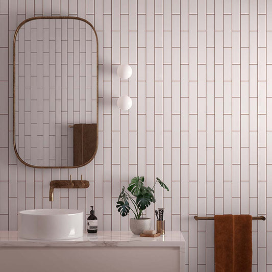 Pink glossy 2x8 ceramic subway wall tile installed in bathroom setting