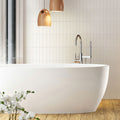 Glossy white ceramic subway tiles 2x8 inches installed on bathroom wall