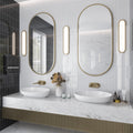 Glossy white 2x8 ceramic subway tiles installed vertically on bathroom wall
