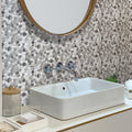 Polished grey marble pebble mosaic tile wall with mixed light and dark gray pebbles, suitable for bathroom walls