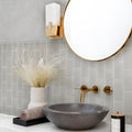 Warm greige 3x6 matte glass subway tile installed on bathroom wall