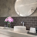 Ash gray 3x6 matte glass subway tile installed as a bathroom backsplash