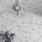 White and blue-gray polished porcelain tiles arranged in 11x12 herringbone mosaic pattern