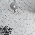 White and blue-gray polished porcelain tiles arranged in 11x12 herringbone mosaic pattern