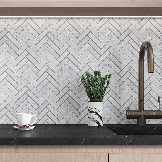 white honed bianco carrara marble herringbone mosaic tile backsplash in kitchen