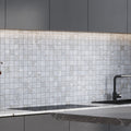 Pale gray 12x12 polished porcelain mosaic tile backsplash with subtle beige veins and polished finish
