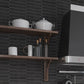 black matte ceramic picket tile backsplash with elongated hexagonal shapes and textured surface