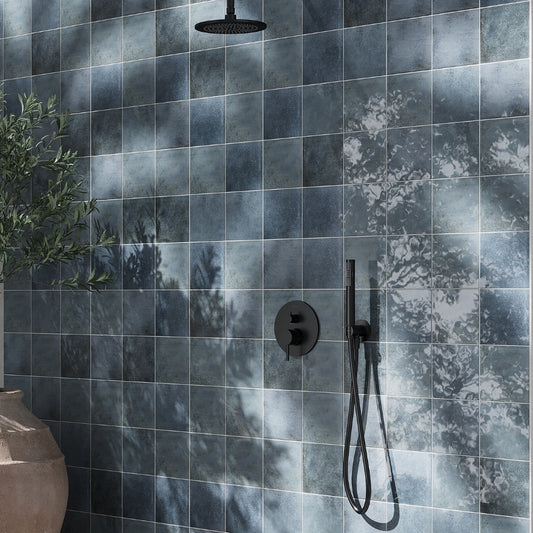 glossy slate blue 6x6 square zellige porcelain tiles with tonal variations on wall