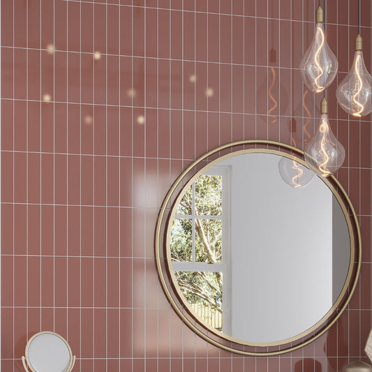 glossy red 2x8 ceramic subway tile installed on wall with white grout