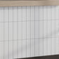 Glossy white 2x8 ceramic subway tiles in a vertical stacked pattern with subtle shadowing