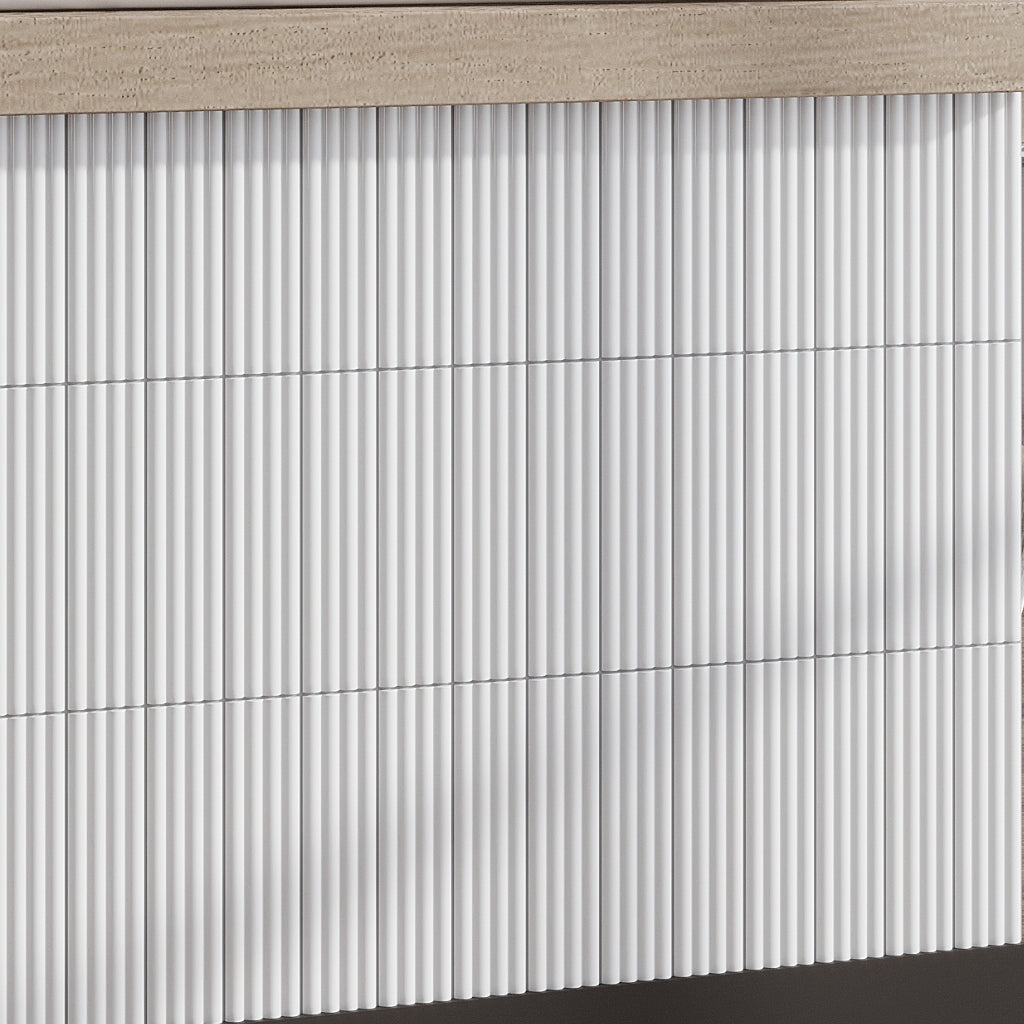 Glossy white 2x8 ceramic subway tiles in a vertical stacked pattern with subtle shadowing