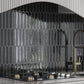 Glossy black 2x10 ceramic picket tiles arranged in vertical backsplash pattern