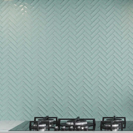 blizzard blue glossy herringbone glass mosaic tile backsplash with oceanic blue tone