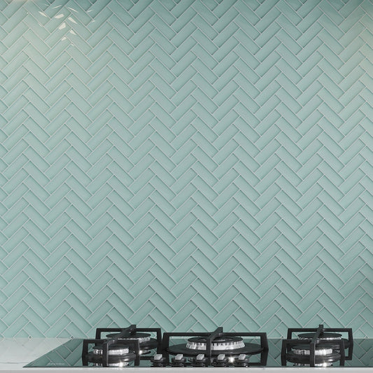 blizzard blue glossy herringbone glass mosaic tile backsplash with oceanic blue tone