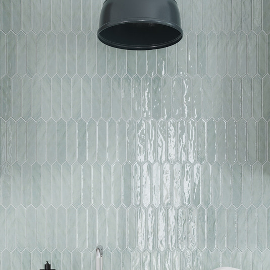 Glossy pistachio green 2x10 ceramic picket tiles in vertical layout with glossy finish