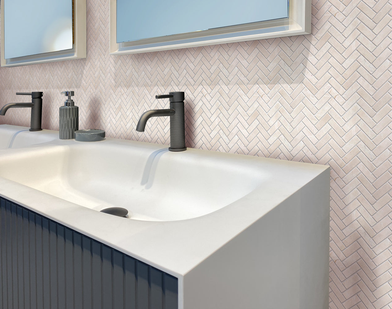 Ivory beige polished Crema Marfil marble tiles in 12x12 herringbone mosaic pattern on wall