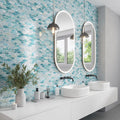 Aqua matte elongated hexagon glass mosaic tile in blue and teal hues on bathroom wall