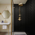 Glossy black glass subway tile 4x16 inches installed in a bathroom shower wall with herringbone pattern