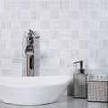 White and gray polished Bianco Carrara marble mosaic, 12x12 inches, installed on bathroom backsplash