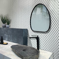 Polished white octagon marble mosaic tile with gray grout on bathroom wall