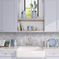 White gray 11x11 polished marble pebble mosaic tile backsplash in kitchen setting