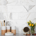 White honed Calacatta gold marble subway tile 4x12 installed on bathroom wall