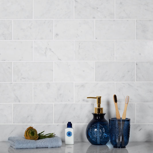 White Bianco Carrara marble subway tile 3x6 honed finish on bathroom wall